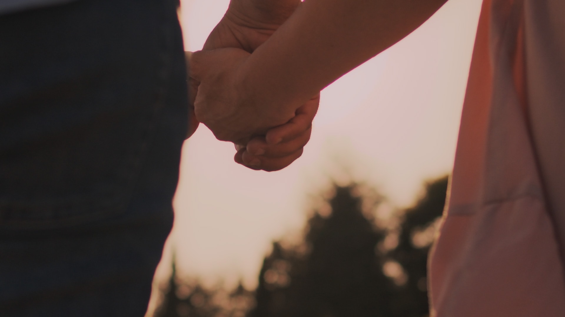 Et par der går i solnedgangen og holder i hånden